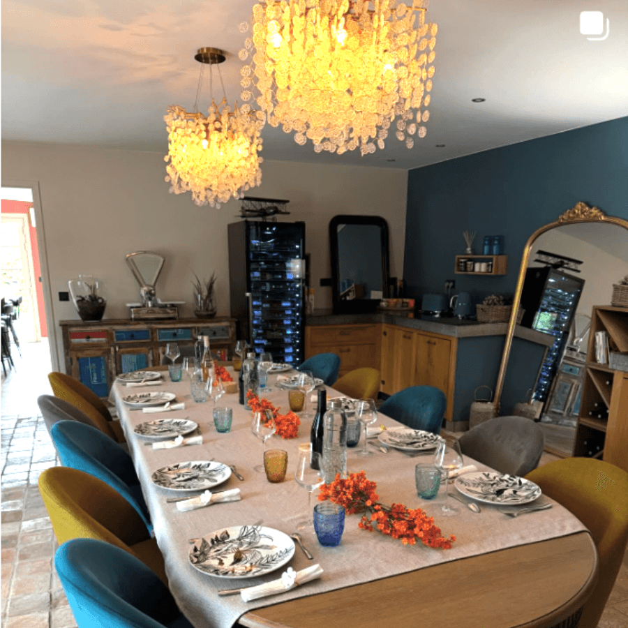 The dining room and its chandeliers, table laid