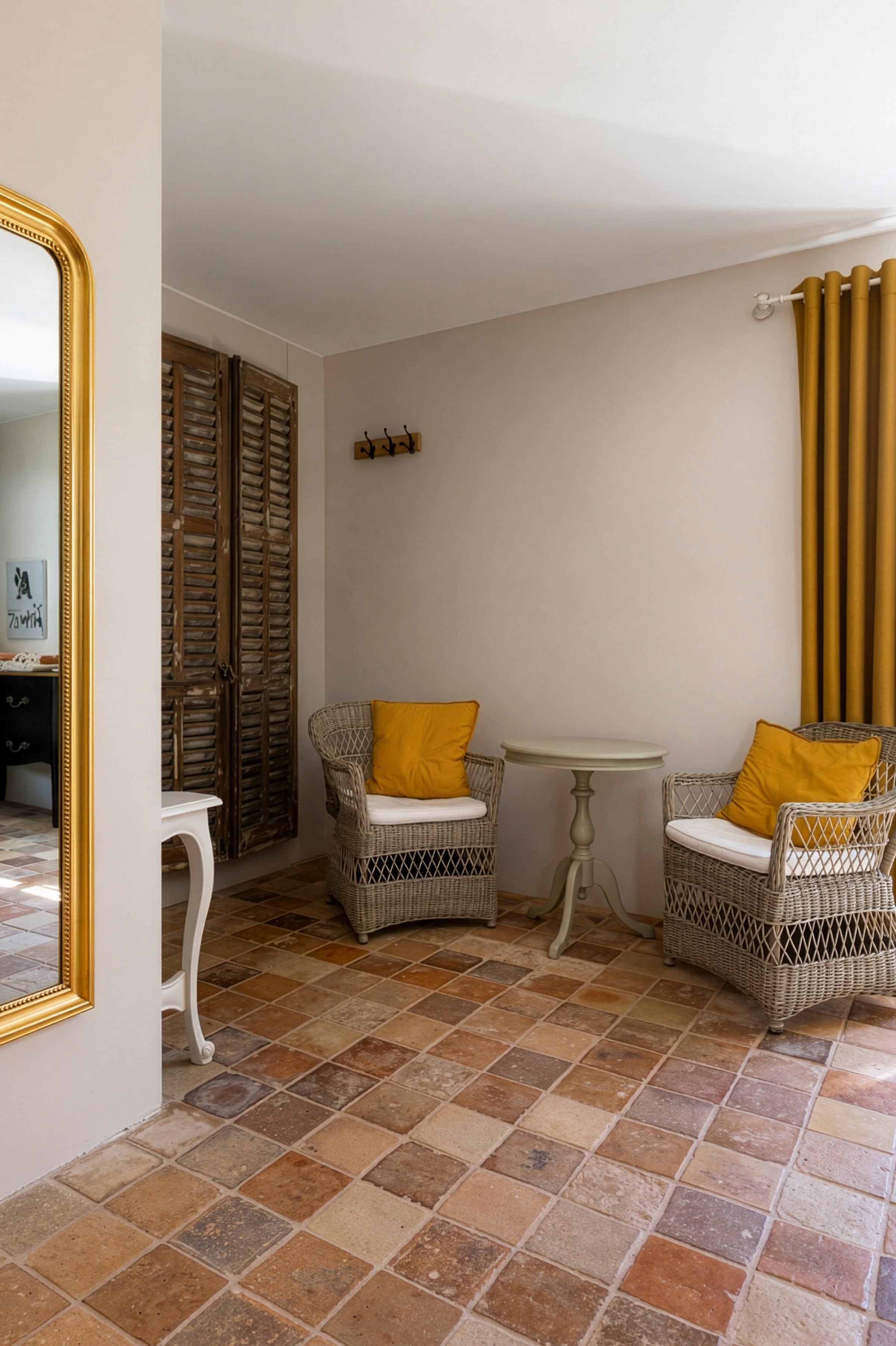 The rattan sitting area and old terracotta tiles