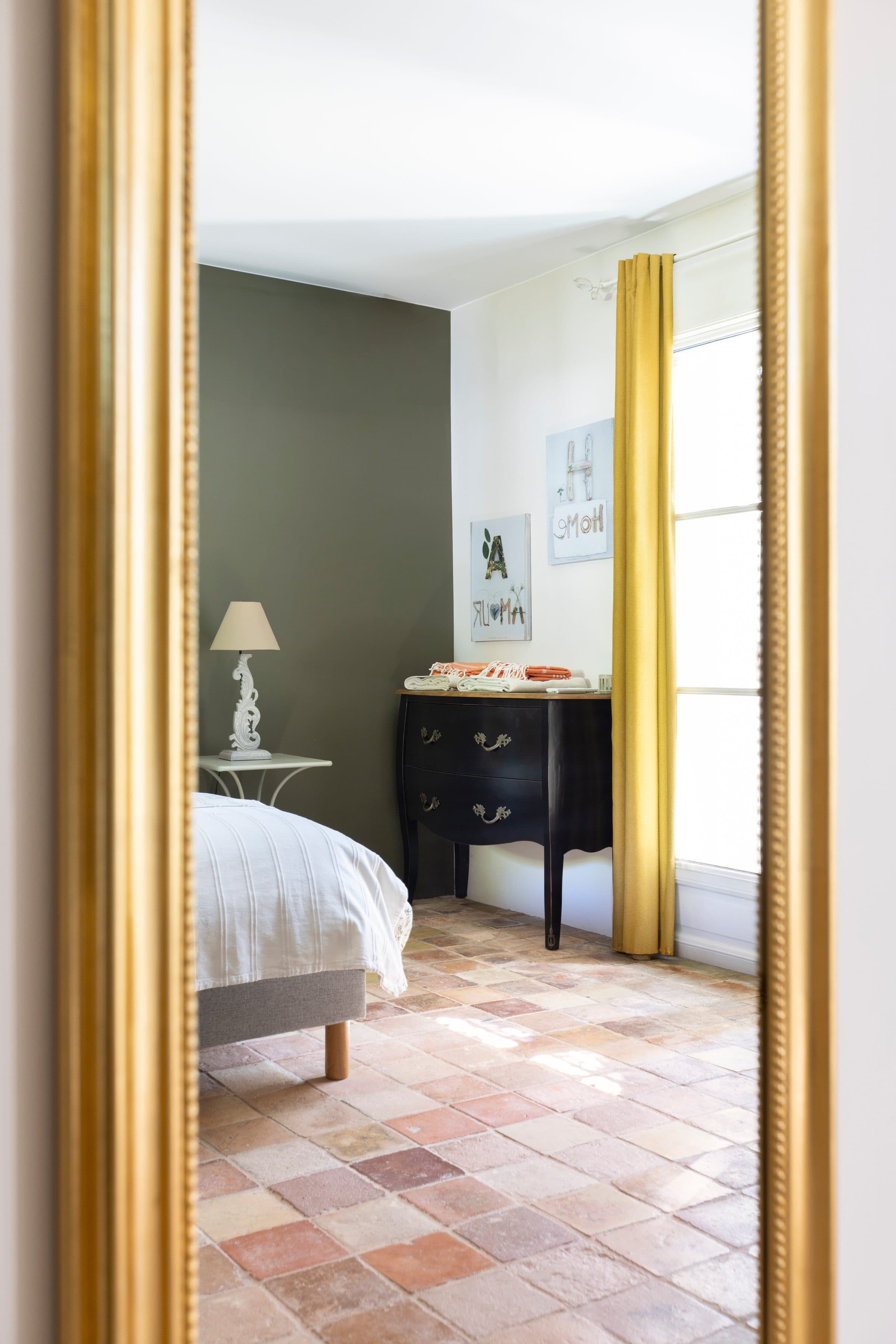 The room reflected in the gilded mirror